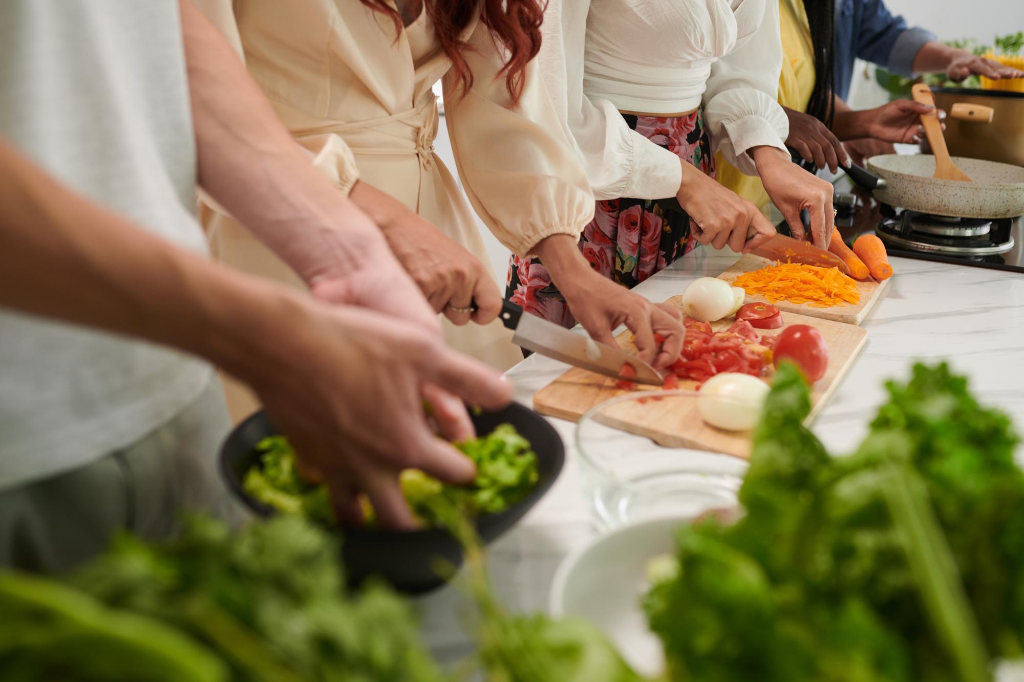 Participants around bench chopping vegetables